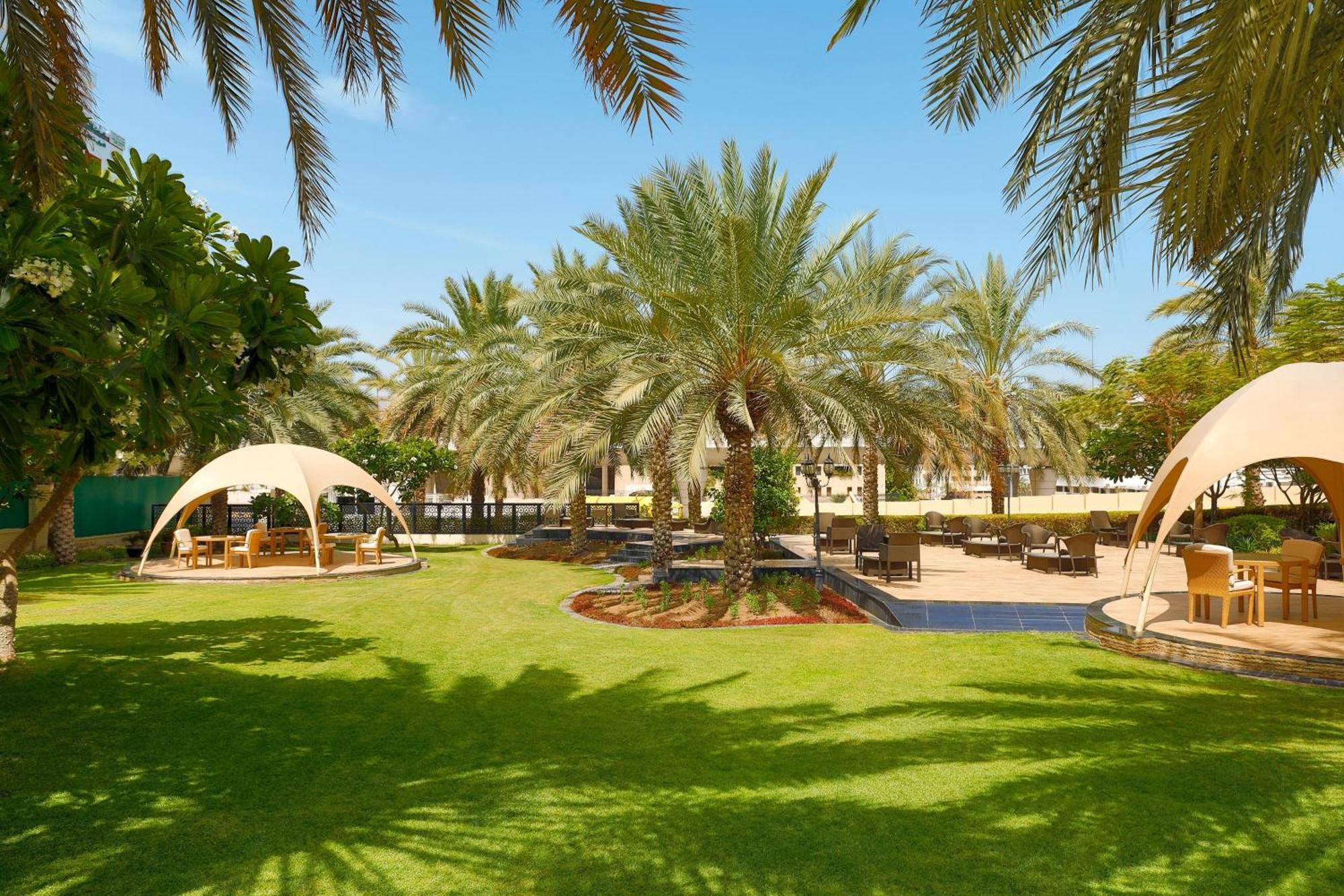 Sheraton Oman Hotel Маскат Екстериор снимка The resort's gardens